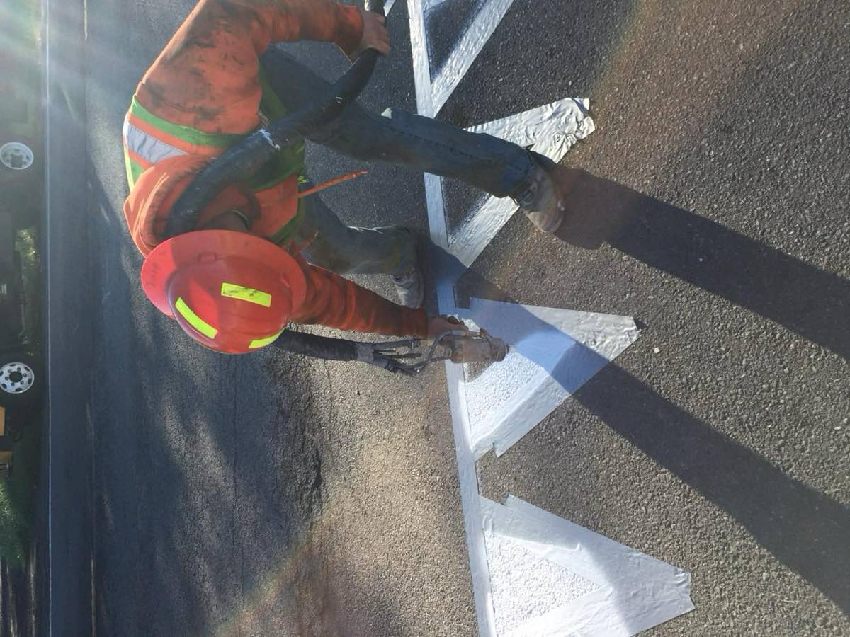 Epoxy striping rig applying pavement markings